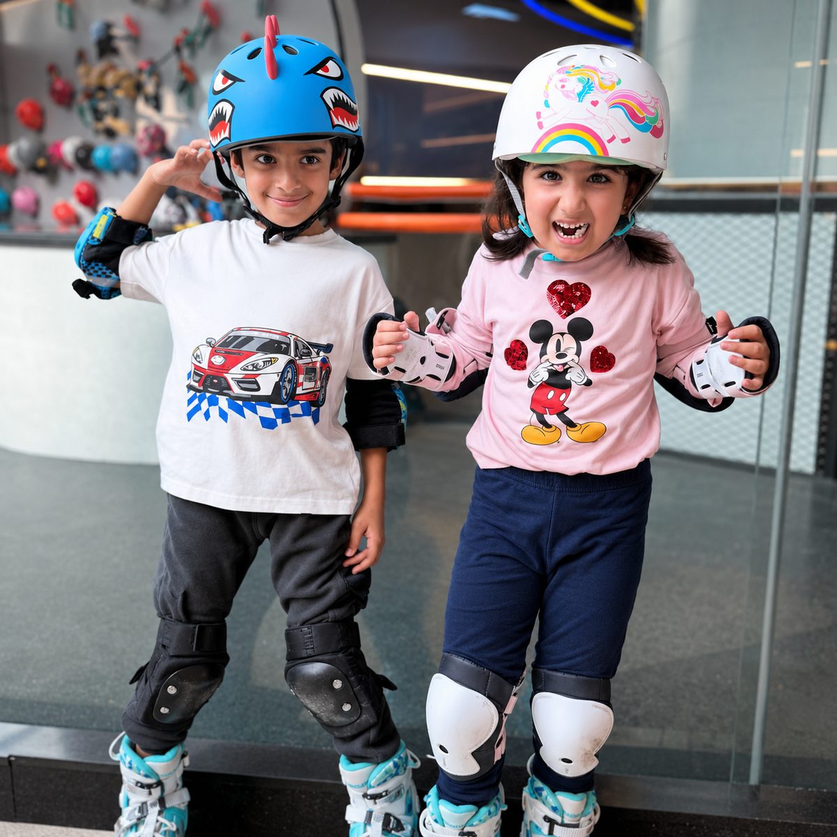 Two happy young skaters in helmets at GoSkate